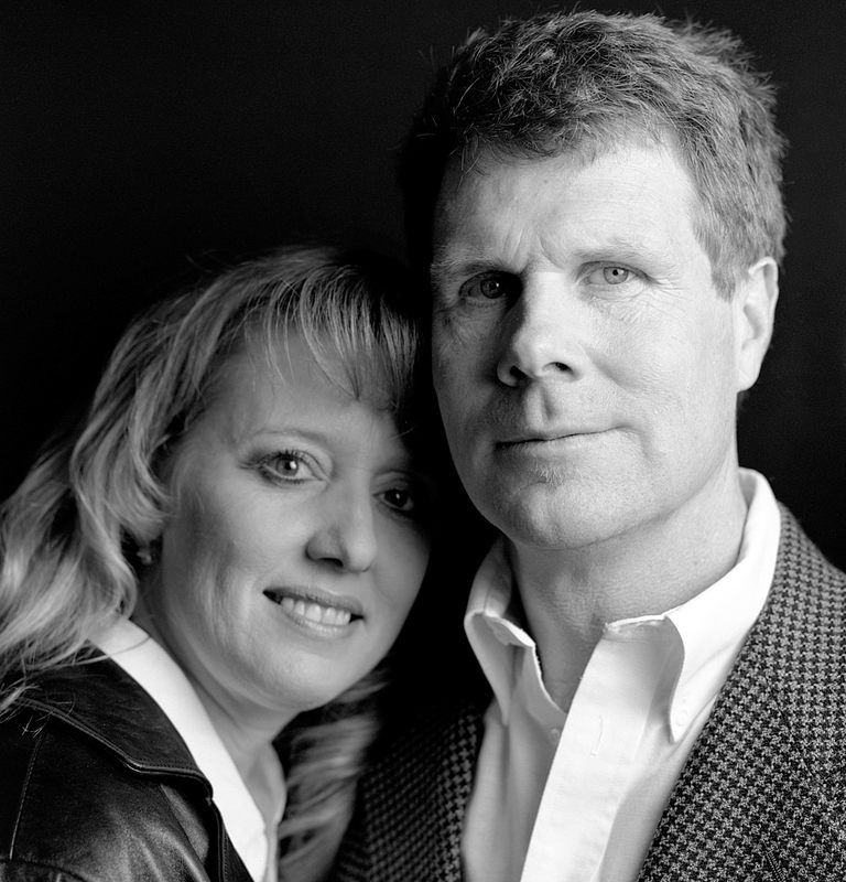 Black and white photo of couple close together. 